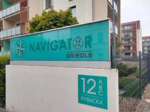 a sign that reads naya r objectle in front of a building at Apartament Nawigator Rybacka 12 b/59 in Kołobrzeg