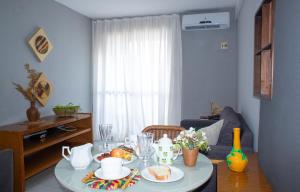 una sala de estar con una mesa con comida. en Flat Residencial Meireles Fortaleza, en Fortaleza