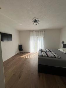 a bedroom with a bed and a television and a window at Apartment DELFIN Jacuzzi , Bribir-Novi Vinodolski in Bribir