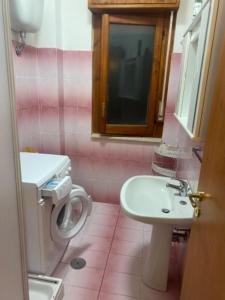 a bathroom with a sink and a toilet at Apartement Mimosa in Scalea +63 photos