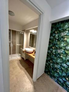 a bathroom with a sink and a mirror at Villa Tra i Pini - Green & Relax in Castellana Grotte