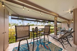 a patio with a table and chairs on a balcony at Eldorado L202 in Kahana
