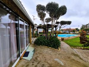 a house with a view of a swimming pool at BeHappy in Ferreira do Zêzere