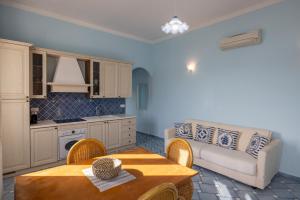a living room with a couch and a table at La Casina Azzurra Sul Mare in Portoferraio