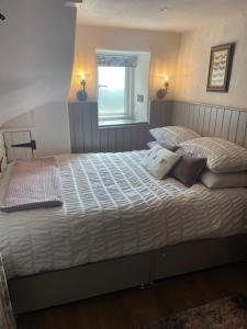 a bedroom with two beds and a window at Church Barn - Private barn perfect for 2 guests stunning location in Bakewell