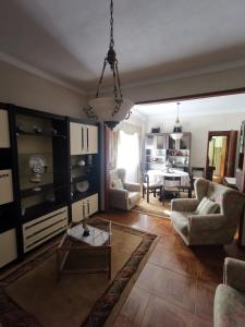 a living room with two chairs and a table at Moradia Coelho in Lousã