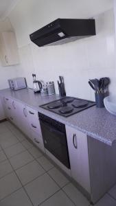 a kitchen with a stove and a counter top at Daffodils Haven in Gaborone