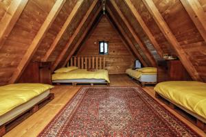 a room with three beds in a attic at Village house Iva in Livno
