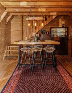 a kitchen with a large wooden table and stools at Village house Iva in Livno