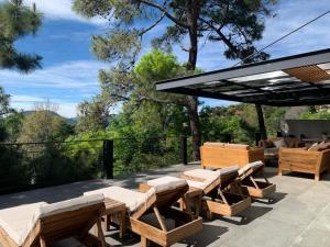 a patio with a bunch of tables and chairs at Majestic Residence with views of the lake and woods! in Valle de Bravo