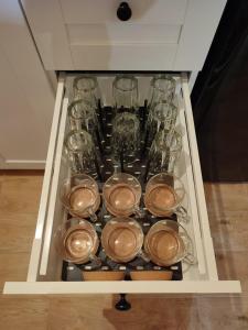a drawer with a bunch of glasses and utensils at Smrekowa Chatka w Milówce in Milówka
