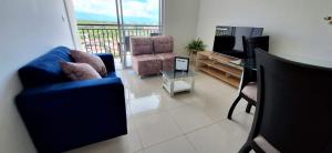 a living room with two chairs and a television at AG APTO con Aire Acondicionado in Neiva