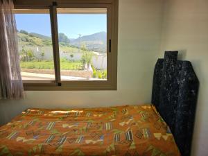 a bedroom with a bed and a window at Good Life Top House Btw Sea & Montain 