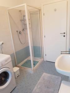 a shower with a glass door in a bathroom at Sottomarina Beach Life in Sottomarina +18 photos