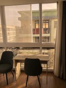 stół i dwa krzesła przed oknem w obiekcie Alhosry rose motel w mieście 6th Of October (Miasto 6 października)