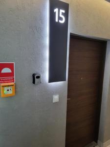 a door with the number on the wall at Apartament DeLuxe 4 in Oświęcim