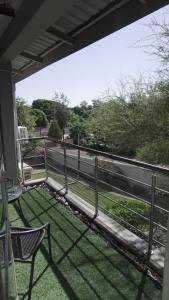 a balcony with a fence and a table and a chair at Daffodils Haven in Gaborone