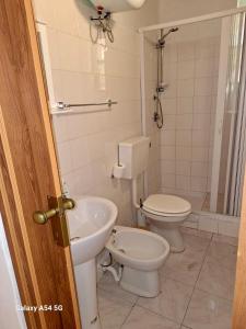 a bathroom with a toilet and a sink at Bentivegna Apartments in Syracuse