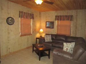 a living room with a leather couch and a table at Riverside Lodge Resort in Inverness +83 photos