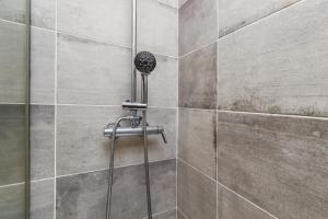 a shower with a shower head in a bathroom at Mia guest House R/C in Setúbal +22 photos