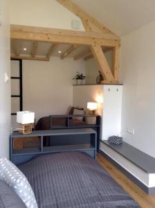 a bedroom with a bed and a desk with two lamps at Les Co Gîte in Vigny