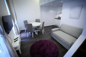 a small living room with a couch and a table at d.Five Chain Bridge Apartment in Budapest