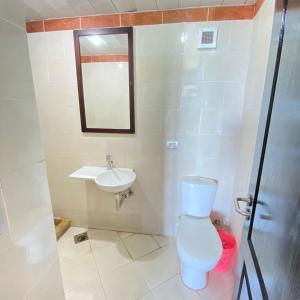 a bathroom with a toilet and a sink at شاليه في بورتو مارينا الساحل الشمالي العلمين 59 in El Alamein