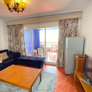 a living room with a couch and a table at شاليه في بورتو مارينا الساحل الشمالي العلمين 59 in El Alamein