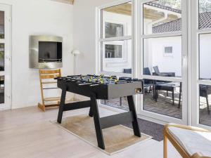 a ping pong table in a living room with a tv at 8 person holiday home in Højslev-By Traum in Højslev +25 photos