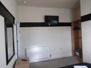 a living room with a tv on a wall at No12 Guesthouse South Shore Blackpool in Blackpool