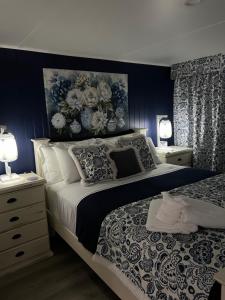 a bedroom with a large bed with blue walls at Rainbows End in Redcliffe