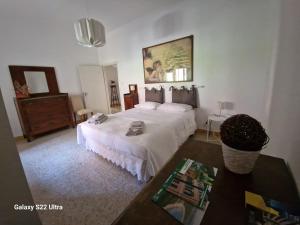 a bedroom with a large bed and a table at Come a casa in Tognazza