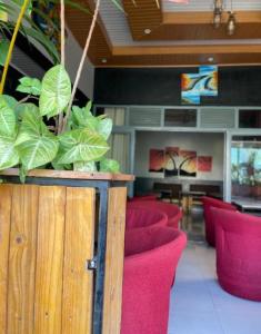 a waiting room with red chairs and plants at The Keza Hotel Botique in Kigali