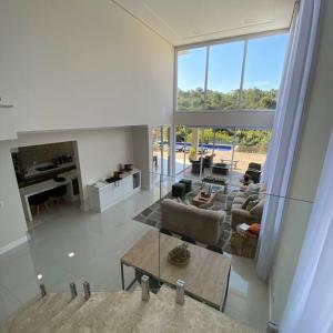 uma sala de estar com lareira e uma grande janela em Casa de campo espetacular condomínio a 50min de SP em Itupeva