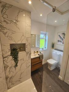 a bathroom with a sink and a toilet at No 2 The Terrace in Rainhull