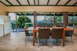 a kitchen and dining room with a table and chairs at Endeavour - Rustic Two-Bedroom Home With Stunning Ocean & 1770 Headland Views in Seventeen Seventy +17 photos