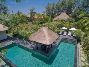an aerial view of a resort with a pool and umbrellas at Luxury Bali Estate Canggu in Munggu +13 photos