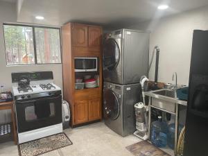 a kitchen with a stove and a washer and dryer at Cheerful 2-Bedroom Cottage Near Eagle Lake in Susanville