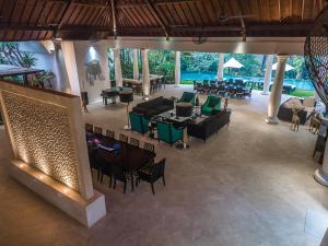 an empty lobby with tables and chairs and tablesktop at Luxury Bali Estate Canggu in Munggu