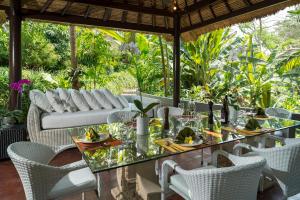 a dining room with a table and chairs at Luxury Bali Estate Canggu in Munggu