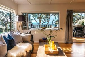 a living room with a couch and a table at ONEROA BEACHFRONT - Coast and Country in Blackpool +22 photos