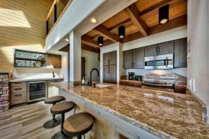 a large kitchen with a large island with stools at Lakeland Village 620 - Beachfront Bliss in South Lake Tahoe