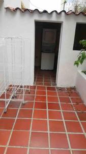 a room with a red tile floor in a house at Seguridad y Tranquilidad in Caracas