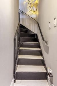 a stairway with a metal railing and a stair case at Room at the heart of East Village 2 in New York