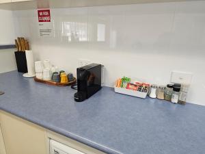 a kitchen counter with a coffee maker on it at Aart Apartments in Port Lincoln
