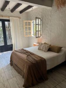 a bedroom with a large bed in a room at Encantadora casa de campo in Ciudad Lujan de Cuyo