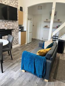 a living room with a couch and a table at Hilltop Place Suites Flat Above 250 in Sheffield