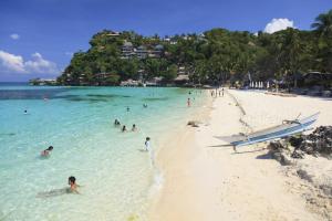 a group of people in the water at a beach at Boracay Luxury Apartments in Boracay
