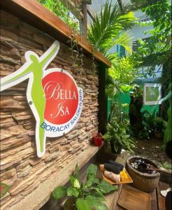 a sign on the side of a building with plants at Boracay Luxury Apartments in Boracay