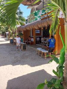 two men standing in front of a restaurant on the beach at Boracay Luxury Apartments in Boracay
